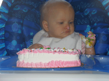 Making a mess with her cake