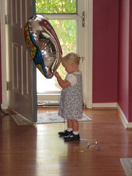 Playing with her balloon