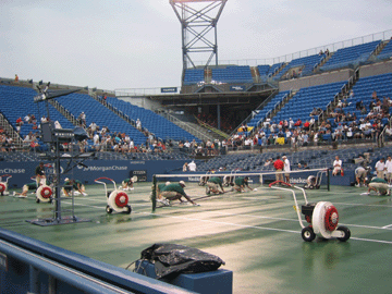 Drying the rain-soaked court