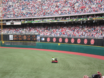 The Phillie Phanatic circling the field with Harry Kalas